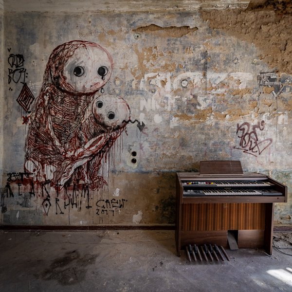 Creature mural beside an electric organ