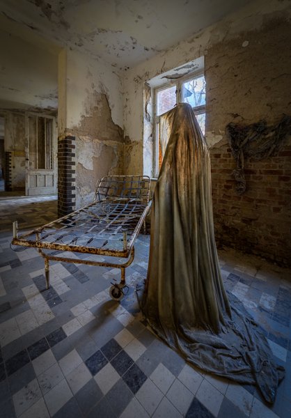 Shrouded figure and bed frame