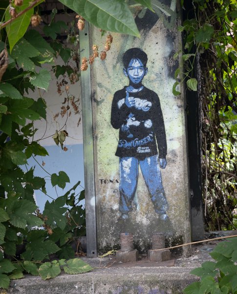 Stencilled boy among the leaves