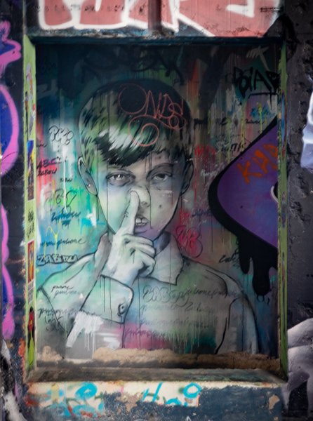 Boy with a finger to his nose