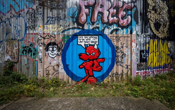 Red devil on a corrugated fence